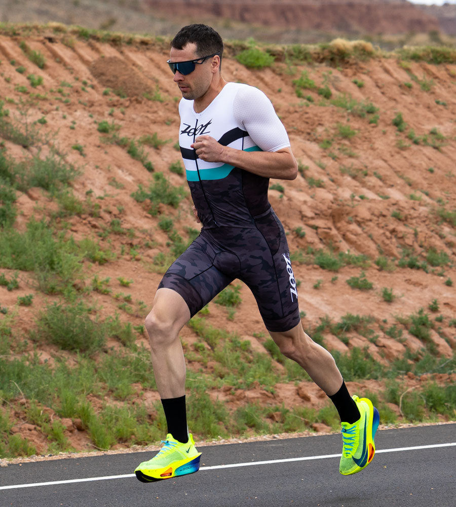Male triathlete running in Camo collection racesuit