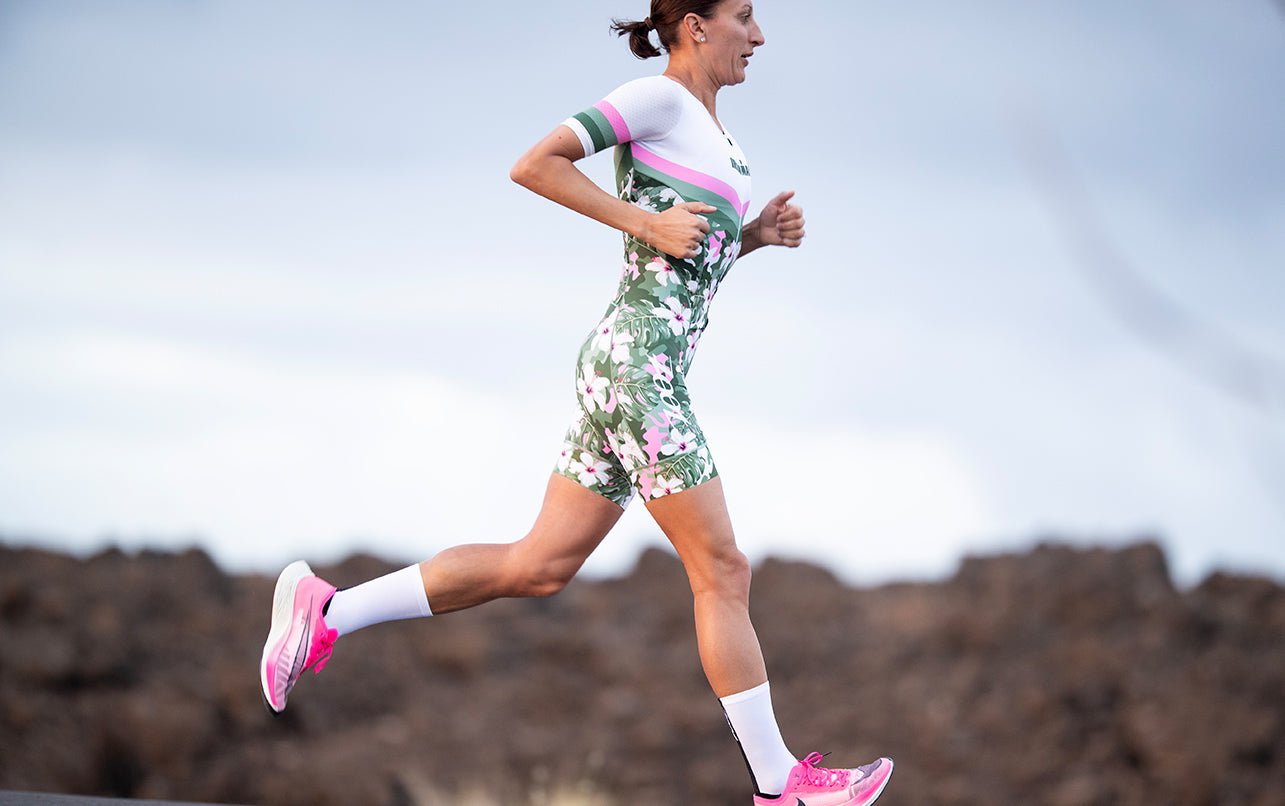 female Triathlete running in Ironman Racesuit