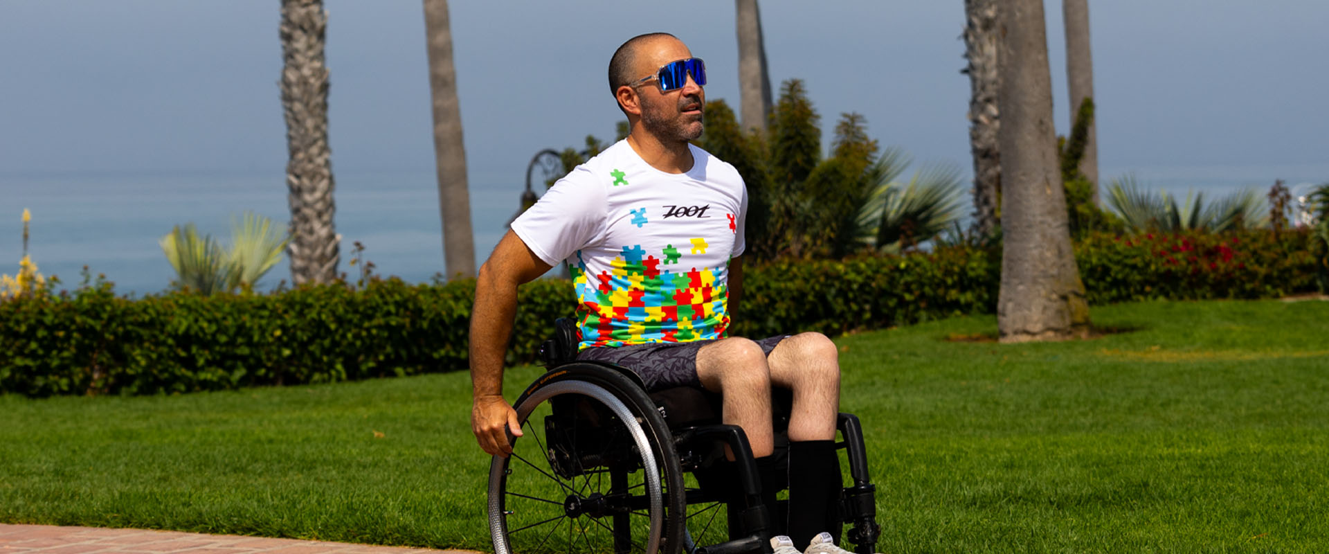 Athlete in wheelchair wearing Autism Ohana Shirt