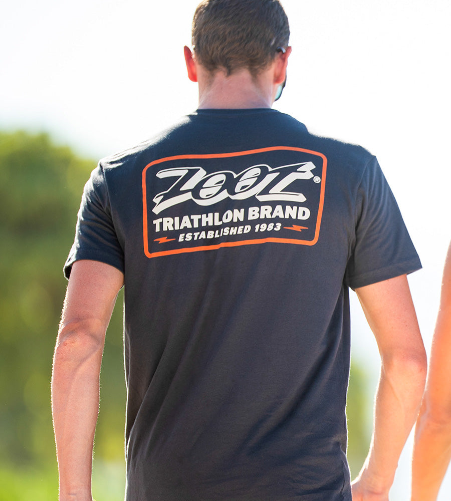 Man walking in tee that has the copy "Zoot triathlon brand"