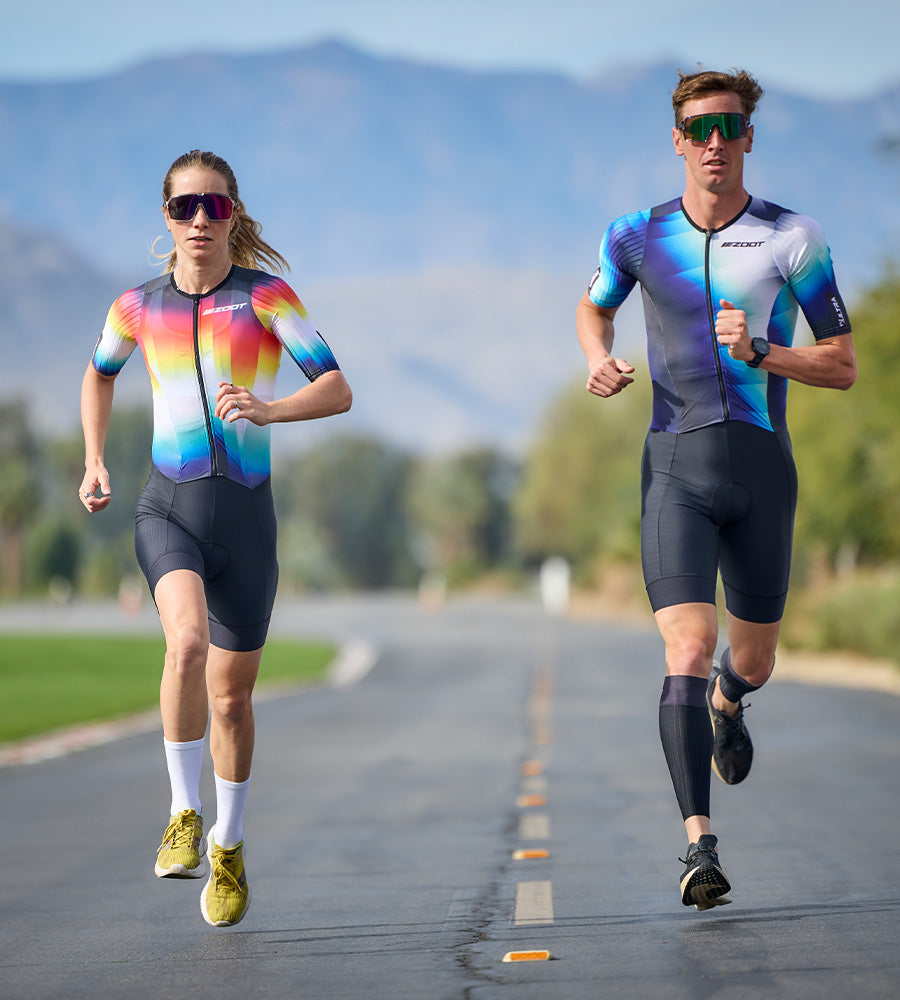 Woman and Man running in P1 racesuit