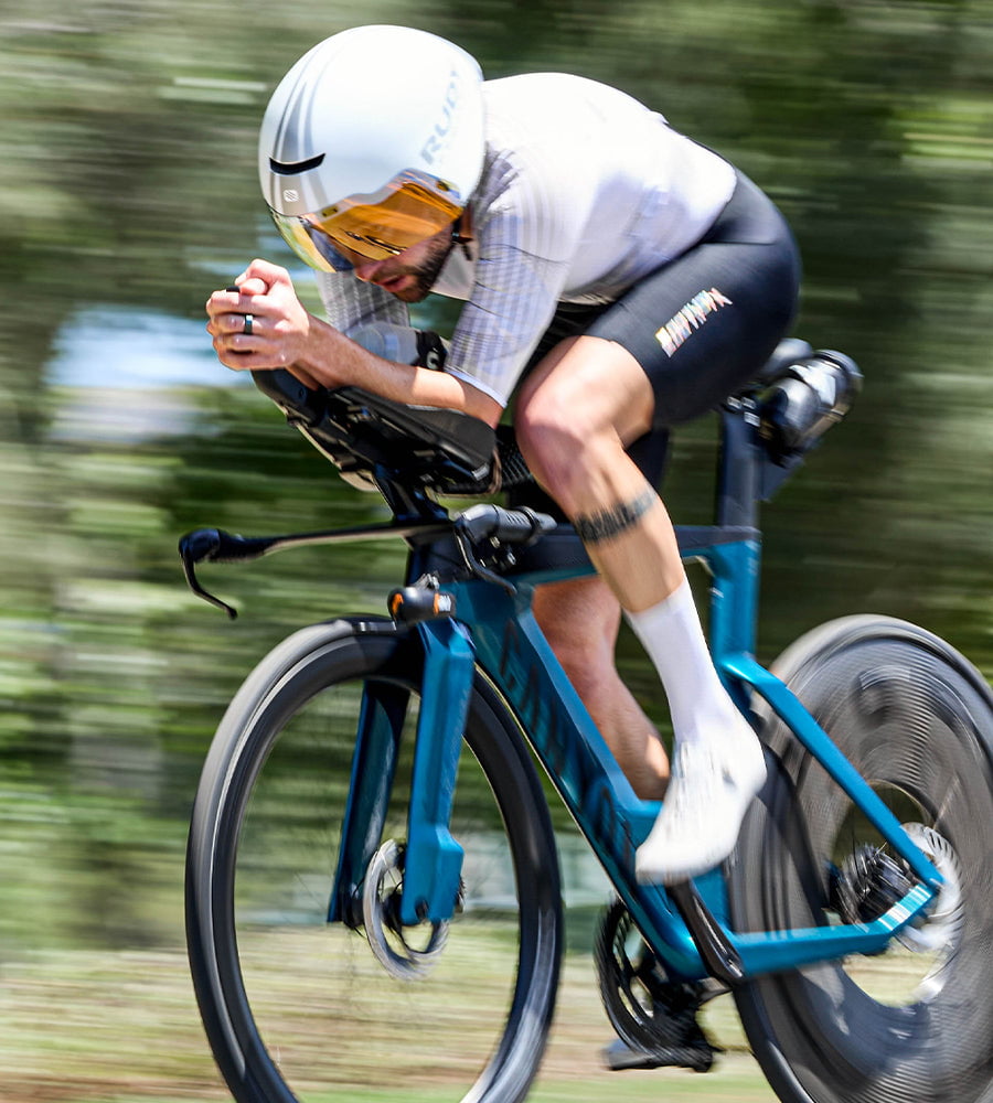 Person riding a time trial bike  wearing the P1x on a blurred background