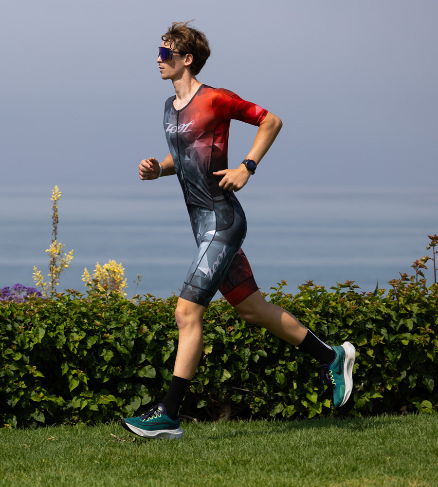 Male athlete running in triathlon racesuit