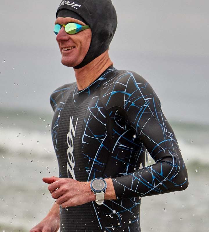 Male in Tundra wetsuit entering ocean